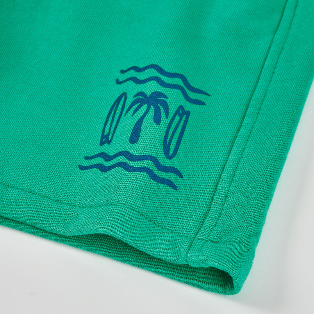 Detailfoto blauwe palmboom met surfboards en golvende lijnen print op felgroene jongens shorts Boboli met omgeslagen zoom – Elisa Kids Boutique