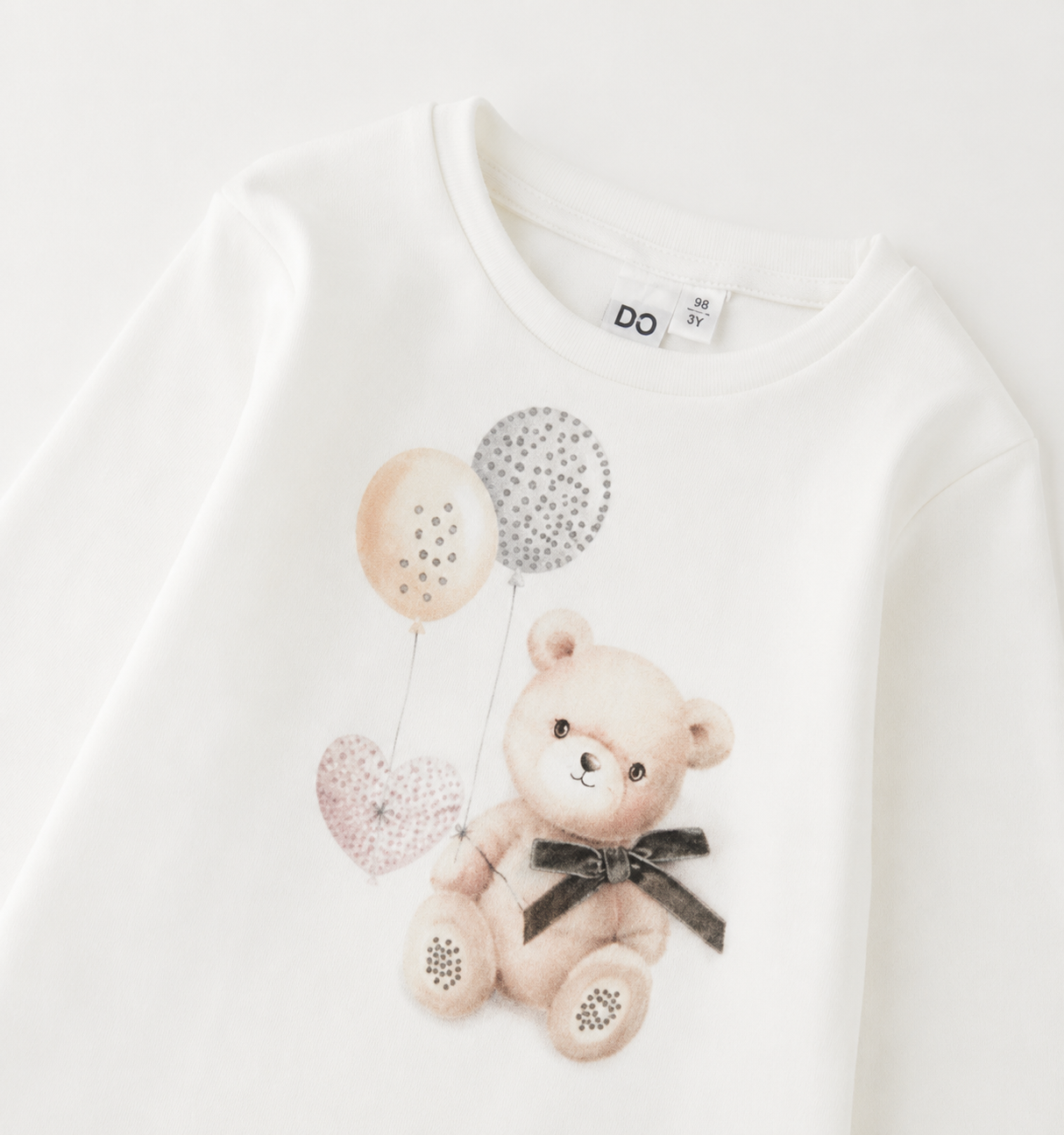 Detail van de beertjesprint met ballonnen, hartje en strikje op het iDO meisjesshirt